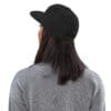 Person wearing a black cap and gray sweatshirt.