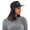 Woman wearing a black cap with "LOVE" text.