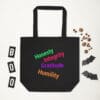 Black tote bag with colorful positive words.