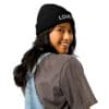 Smiling person wearing a black beanie.