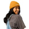 Smiling person wearing an orange beanie.
