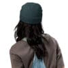 Person wearing a dark beanie and overalls.