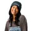 Smiling person wearing a "Love Is" beanie.
