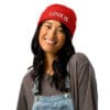 Smiling person wearing a red beanie hat.