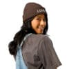 Smiling woman wearing a brown beanie.