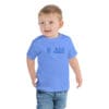 Child wearing a blue t-shirt with text.