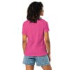 Woman wearing a pink shirt and shorts.