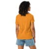 Woman wearing an orange t-shirt and shorts.