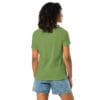 Woman in green shirt and denim shorts.