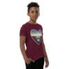 Boy wearing "God Loves You" graphic t-shirt.